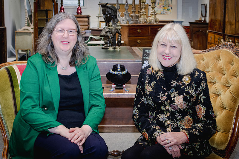 Penny and Denise sitting within Gildings auction viewing