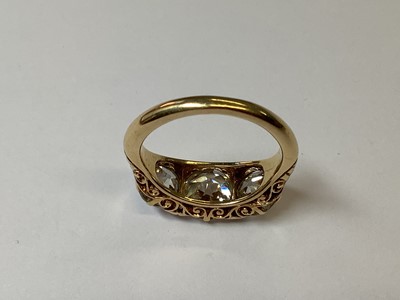 Lot 49 - A diamond three stone ring in carved claw mount.