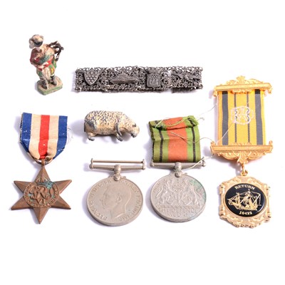 Lot 235 - Seven World War II medals, two lead figures, bracelet.