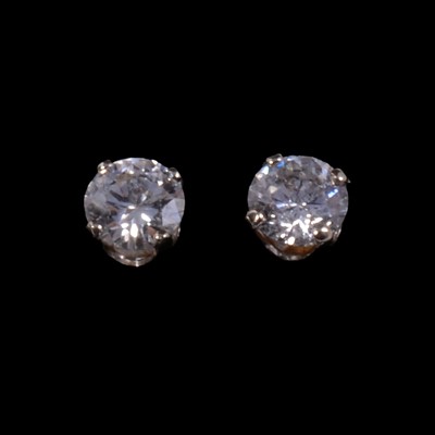 Lot 217A - A pair of solitaire diamond stud earrings.