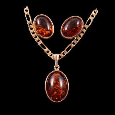 Lot 283 - A 9 carat yellow gold amber pendant and earring suite.