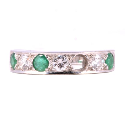 Lot 3 - An emerald and diamond half eternity ring, missing one emerald.