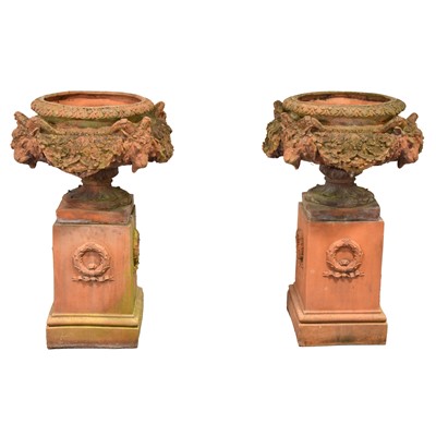 Lot 535 - Pair of large terracotta garden urns on plinths