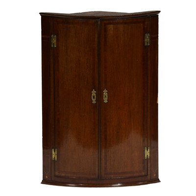 Lot 369 - George IV oak and mahogany bow-front hanging corner cupboard