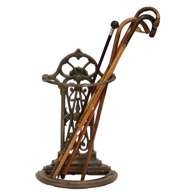 Lot 360 - Cast metal stick stand and five walking sticks and cane