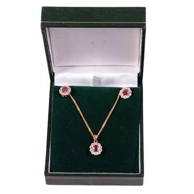 Lot 269 - An ruby and diamond pendant and chain with matching earrings.