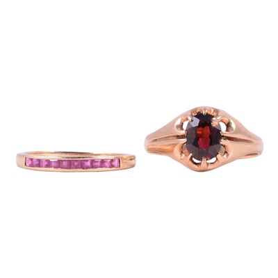 Lot 34 - A ruby half eternity ring and a garnet solitaire ring.