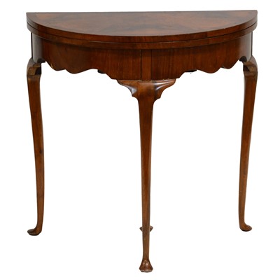 Lot 417 - Small walnut demilune foldover card table, Georgian style