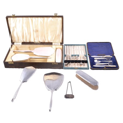 Lot 247 - Two silver-backed dressing table sets, silver coffee spoons, Gin label and small silver-plated serving set.