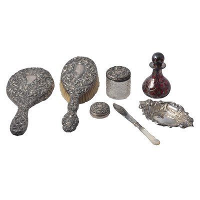 Lot 227 - A silver backed hand mirror and hair brush, two silver topped glass trinket pots.