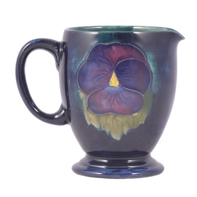 Lot 8 - William Moorcroft for Moorcroft Pottery, 'Pansy' a milk jug, circa 1925