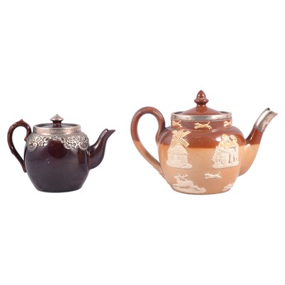 Lot 27 - Royal Doulton stoneware teapot, silver mounted, and a treacle-glazed teapot