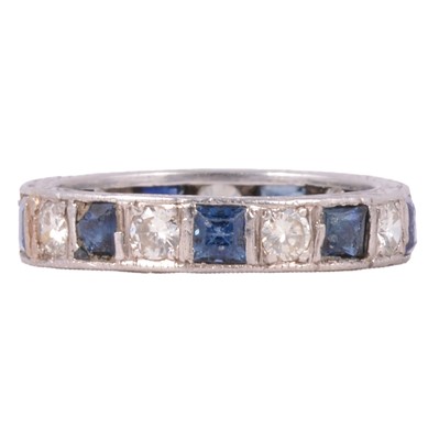 Lot 20 - A sapphire and diamond full eternity ring.