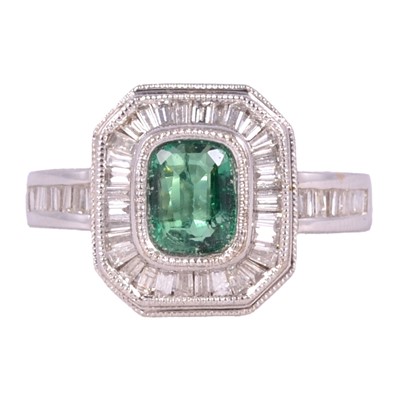 Lot 40 - An emerald and diamond cluster ring.