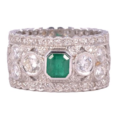 Lot 41 - An emerald and diamond dress ring.