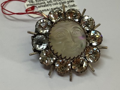 Lot 331 - A graduated paste riviere necklace, large Eisenberg dress clip, Man In The Moon brooch.