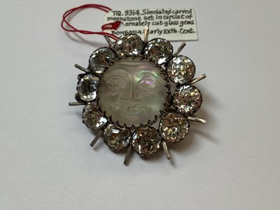 Lot 331 - A graduated paste riviere necklace, large Eisenberg dress clip, Man In The Moon brooch.