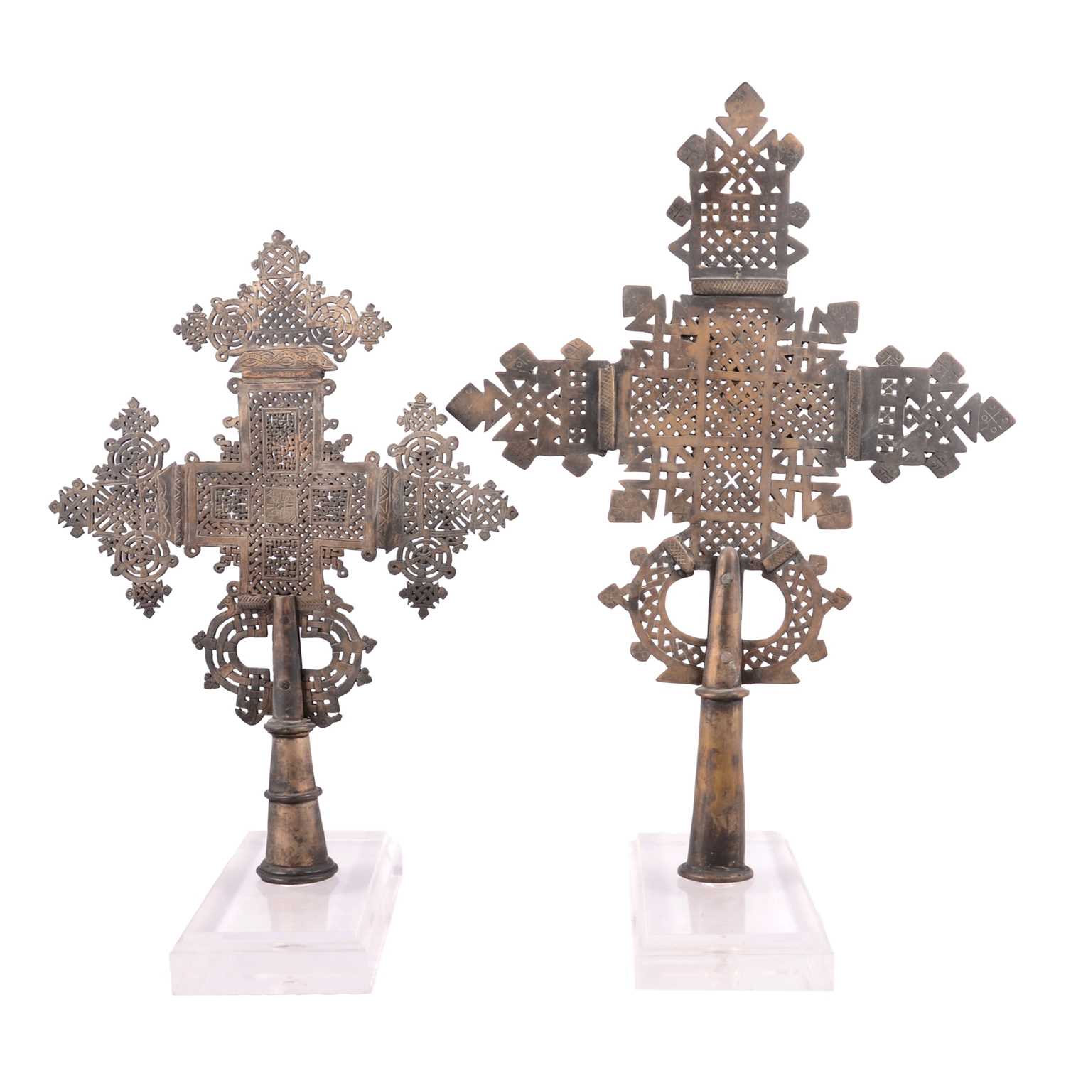 Lot 89 - Two Coptic style metal crosses, on Perspex stands