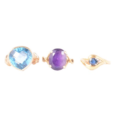 Lot 48 - Three dress rings, amethyst, heat treated blue topaz, sapphire and diamond.