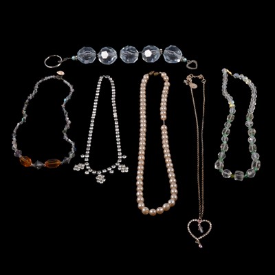 Lot 487 - A collection of costume jewellery necklaces and pendants on chains.