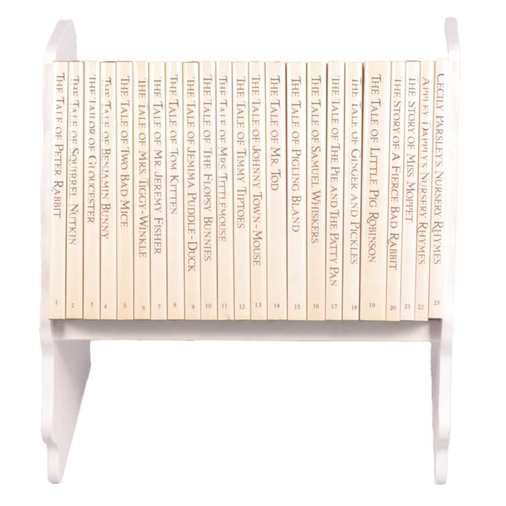 Lot 146 - Set of twenty three Peter Rabbit Books, in a themed book rack