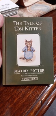 Lot 146 - Set of twenty three Peter Rabbit Books, in a themed book rack