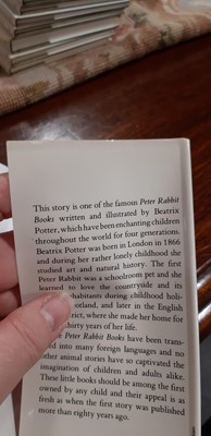 Lot 146 - Set of twenty three Peter Rabbit Books, in a themed book rack