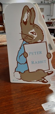 Lot 146 - Set of twenty three Peter Rabbit Books, in a themed book rack