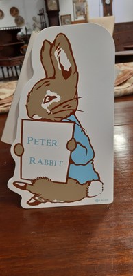 Lot 146 - Set of twenty three Peter Rabbit Books, in a themed book rack