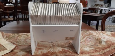 Lot 146 - Set of twenty three Peter Rabbit Books, in a themed book rack