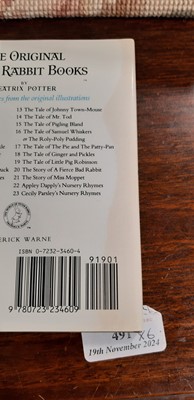 Lot 146 - Set of twenty three Peter Rabbit Books, in a themed book rack