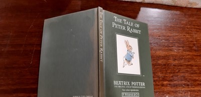 Lot 146 - Set of twenty three Peter Rabbit Books, in a themed book rack