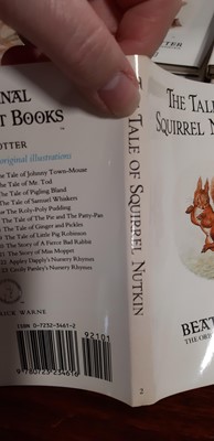 Lot 146 - Set of twenty three Peter Rabbit Books, in a themed book rack