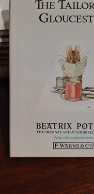 Lot 146 - Set of twenty three Peter Rabbit Books, in a themed book rack