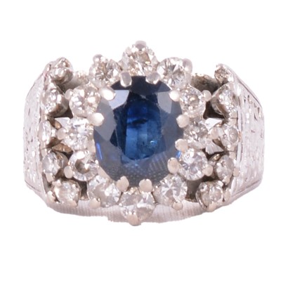 Lot 25 - A vintage sapphire and diamond cluster ring.