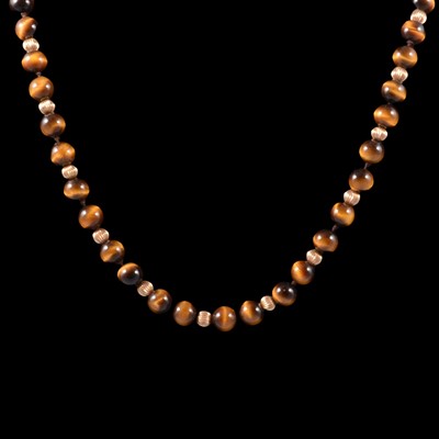 Lot 388 - A tiger's eye bead and gold-coloured bead necklace.