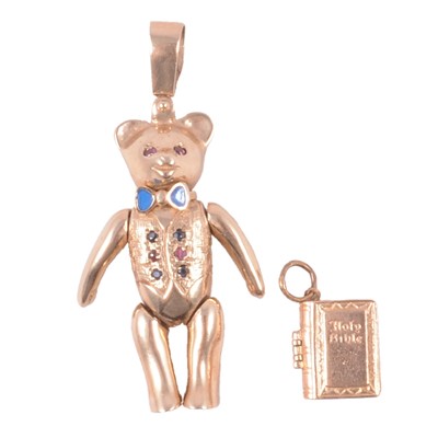 Lot 321 - A 9 carat yellow gold teddy bear pendant and Bible charm.