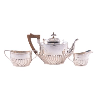 Lot 301 - A silver three piece bachelor teaset, Walker & Hall, Sheffield 1895.