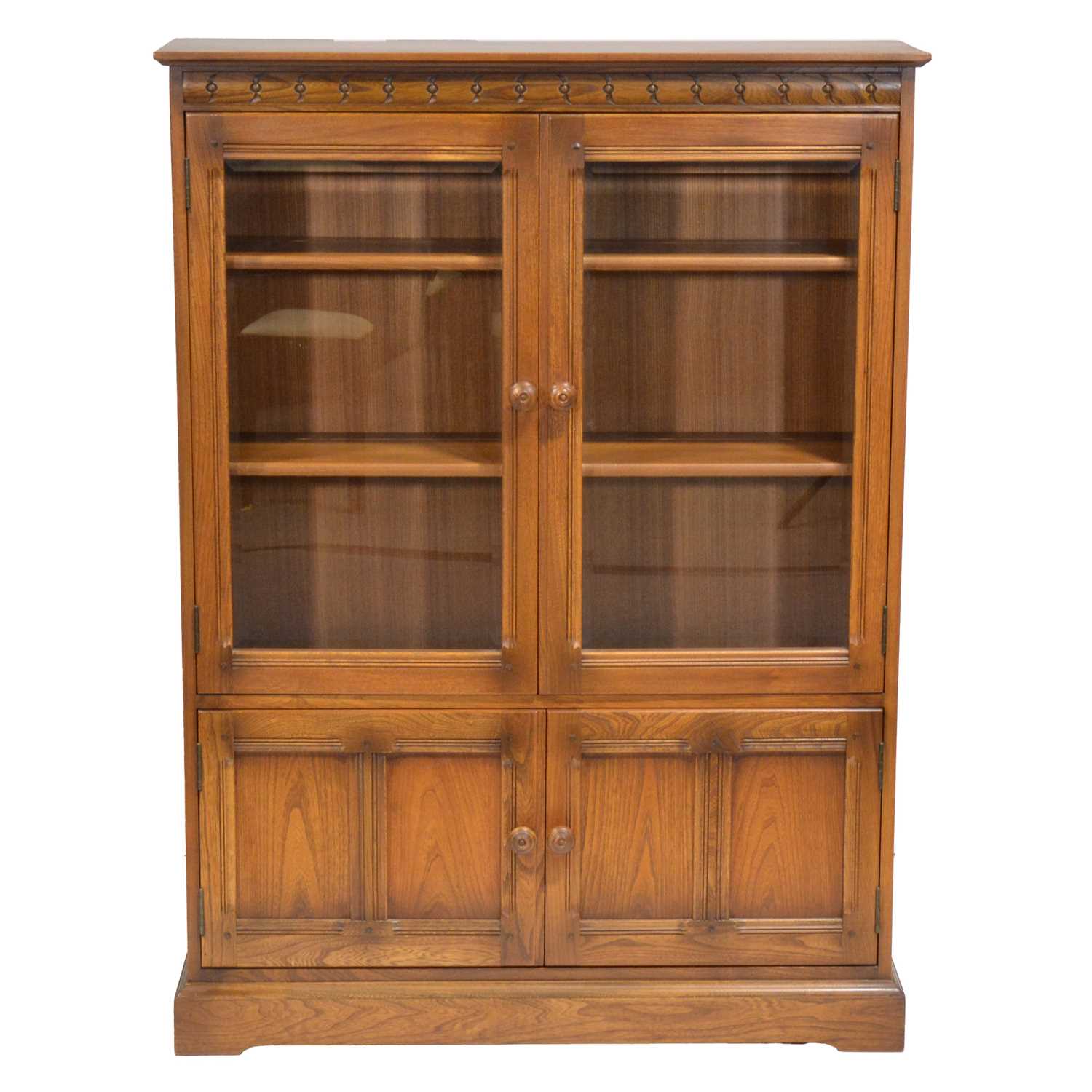 Lot 397 - Ercol mid-elm two door bookcase