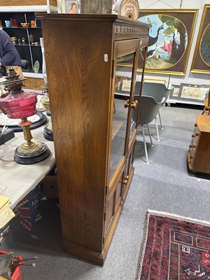 Lot 397 - Ercol mid-elm two door bookcase