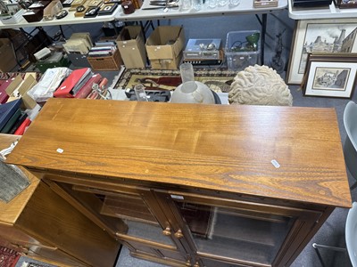Lot 397 - Ercol mid-elm two door bookcase