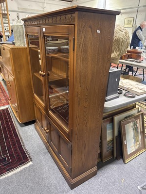 Lot 397 - Ercol mid-elm two door bookcase
