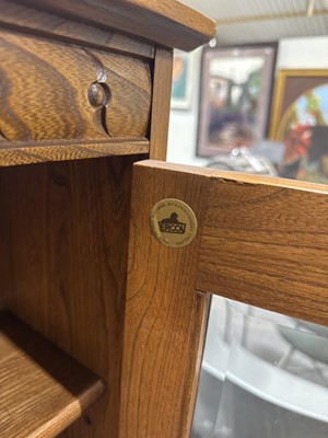 Lot 397 - Ercol mid-elm two door bookcase