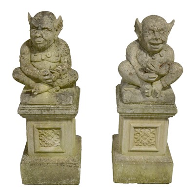 Lot 466 - Pair of reconstituted stone garden ornaments, designed as imps on plinths