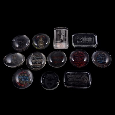 Lot 94 - A collection of advertising glass paperweights