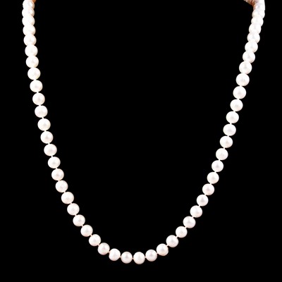 Lot 376 - A rope of cultured freshwater pearls with circular jade rondel.