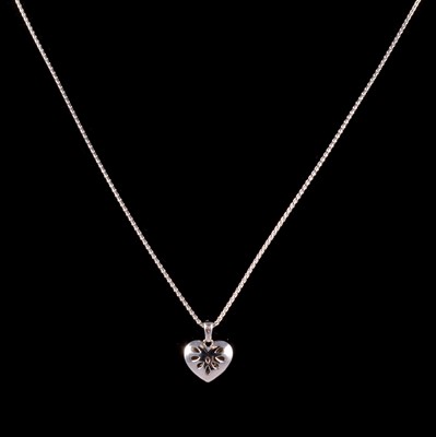 Lot 339 - A platinum heart pendant and chain.