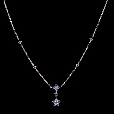 Lot 311 - A tanzanite necklace and two tanzanite pendants on chains.