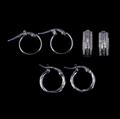 Lot 275 - A pair of platinum hoop earrings, and two pairs of 9 carat white gold earrings, one diamond set.