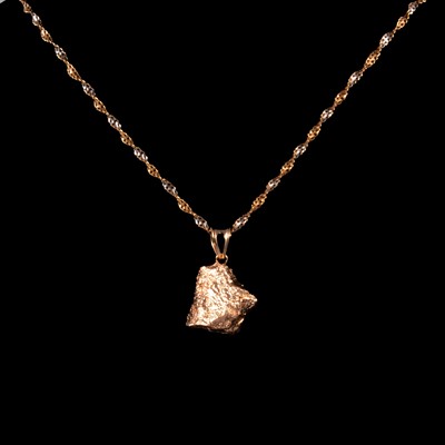 Lot 331 - A 9 carat yellow gold hollow nugget pendant on a yellow and white gold chain.